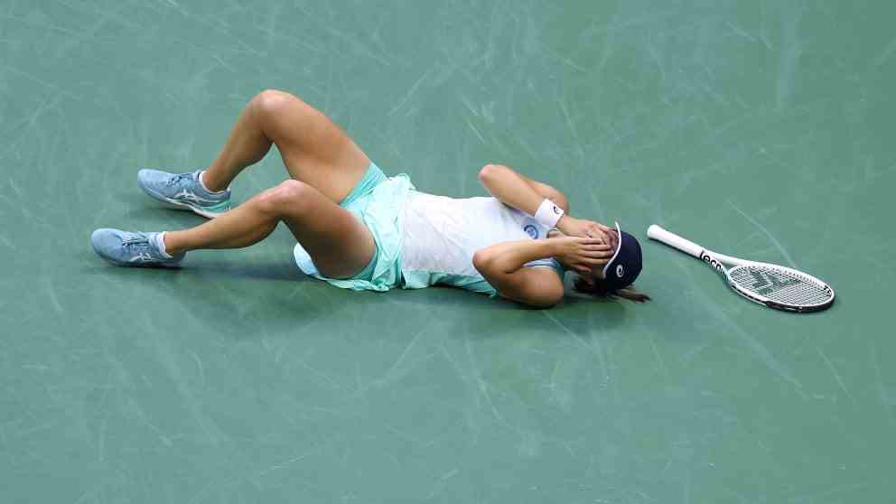 After her win, Swiatek fell backwards onto the hard court and covered her face with both hands