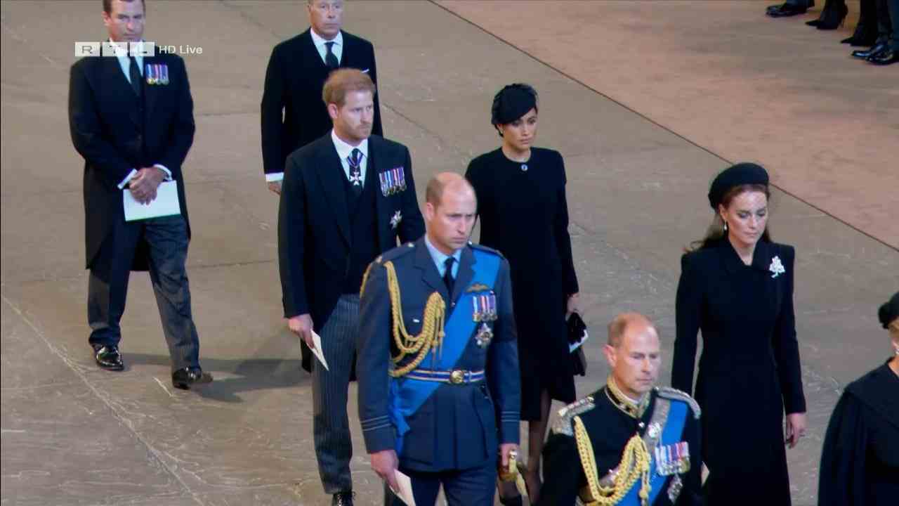 Prince Harry & Duchess Meghan hold hands at the Queen's coffin