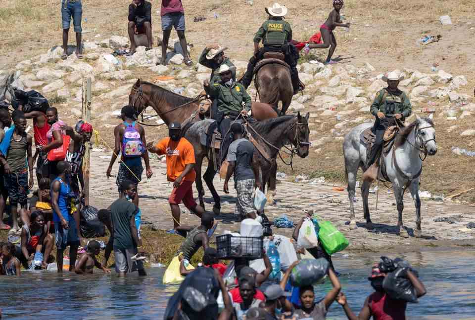 US Customs and Border Protection officers on horseback try to stop Haitian migrants