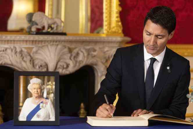 Canadian Prime Minister Justin Trudeau signs a book of condolences in honor of Queen Elizabeth II, at Lancaster House, London, September 17, 2022.