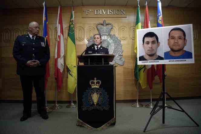 Royal Canadian Mounted Police Assistant Commissioner Rhonda Blackmore at a news conference in Regina, Saskatchewan, Sept. 4, 2022, with portraits of the two suspects in the stabbing attacks that occurred earlier in the day.