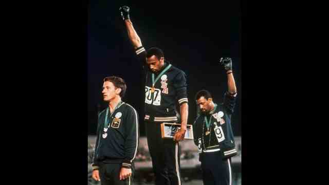 SZ series: Olympic legacy: Banned at the Olympics at the time: American track and field athletes Tommie Smith (middle) and John Carlos (right) raise their fists in the air at the 1968 games in Mexico City to protest against racism.