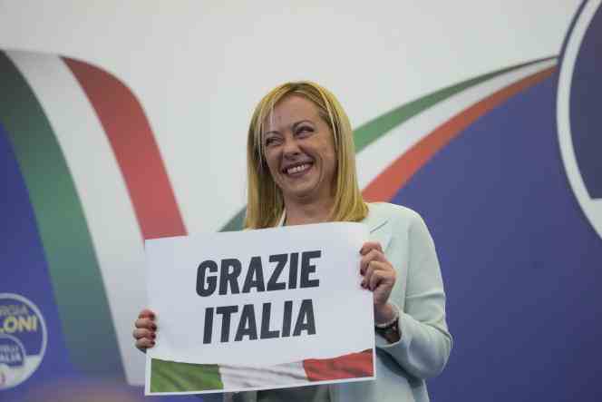 The leader of the far-right Fratelli d'Italia party, Giorgia Meloni, shows a sign saying 