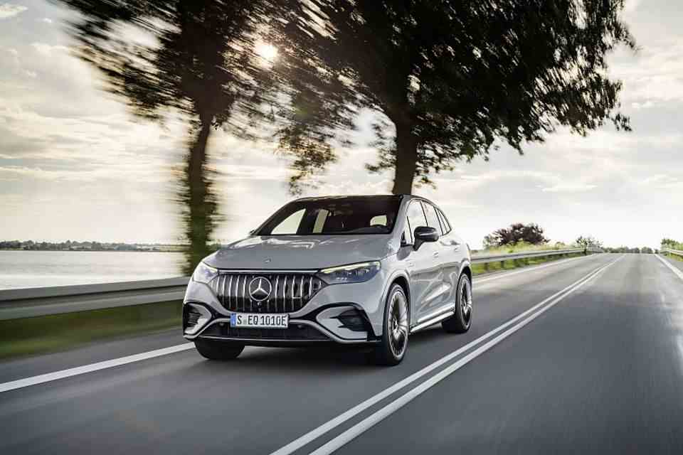 The Mercedes EQE SUV drives on a road
