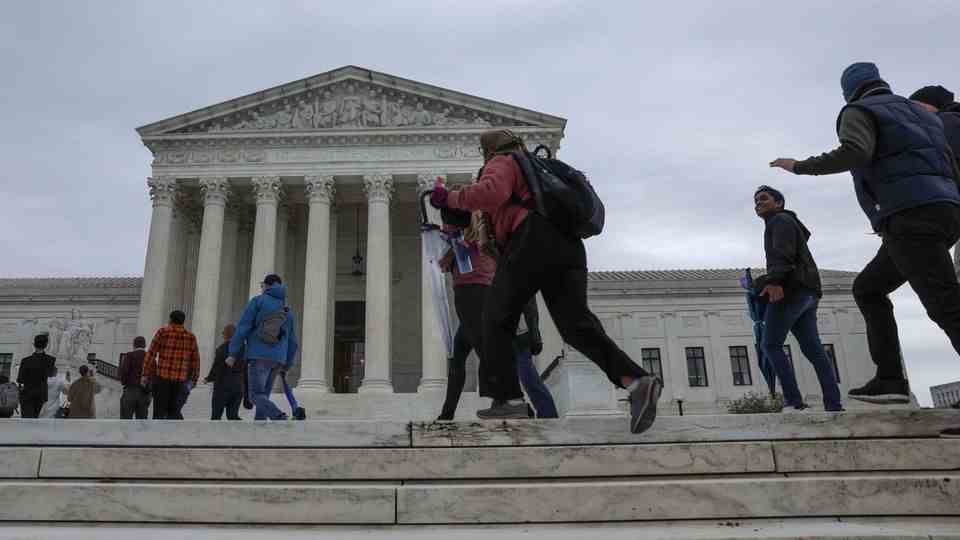 People rush into the US Supreme Court in Washington DC