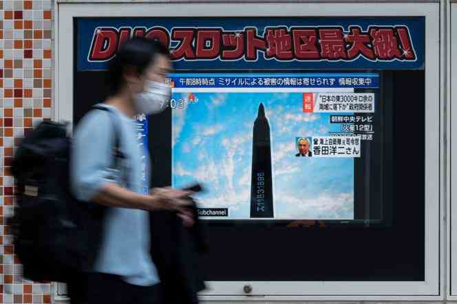 A man walks past a television screen broadcasting a report on an early morning North Korean missile launch which triggered an evacuation alert in northeast Japan, in Tokyo on October 4, 2022.