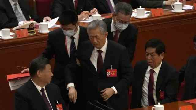 Party congress in Beijing: Hu Jintao is led from the podium at the end of the party congress.