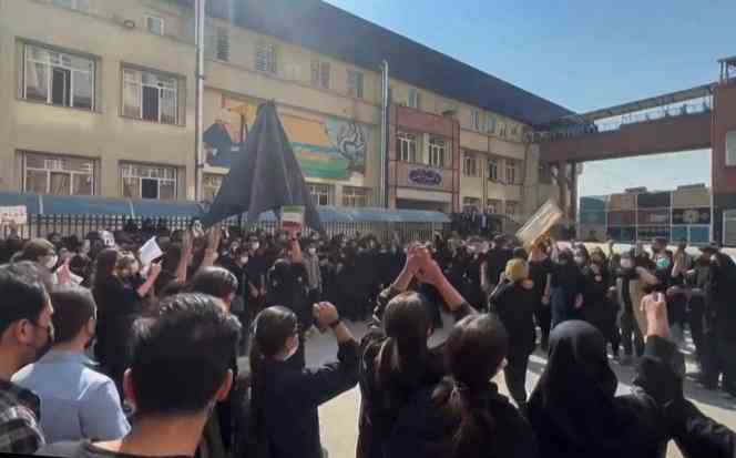 This still image from a video released on October 15, 2022 shows Iranian female students chanting 