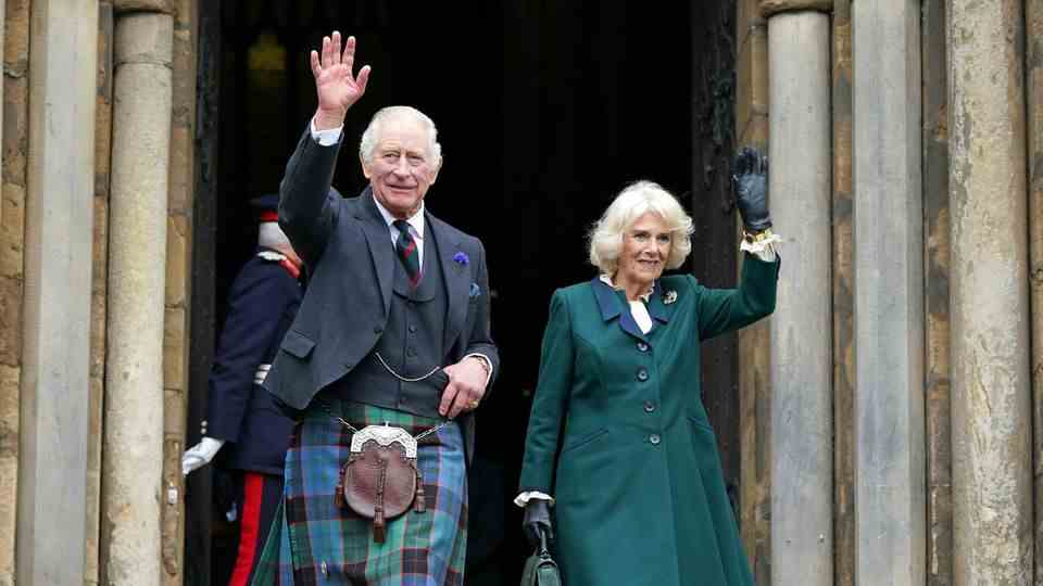 King Charles III  and Camilla wave as they leave Dunfermline Abbey