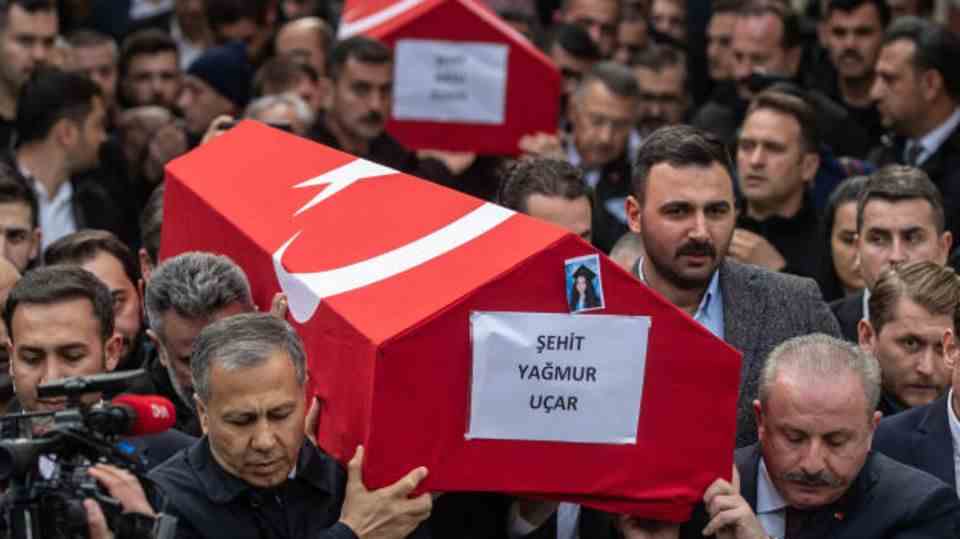 In Istanbul, people carry the coffins of the victims of Sunday's attack