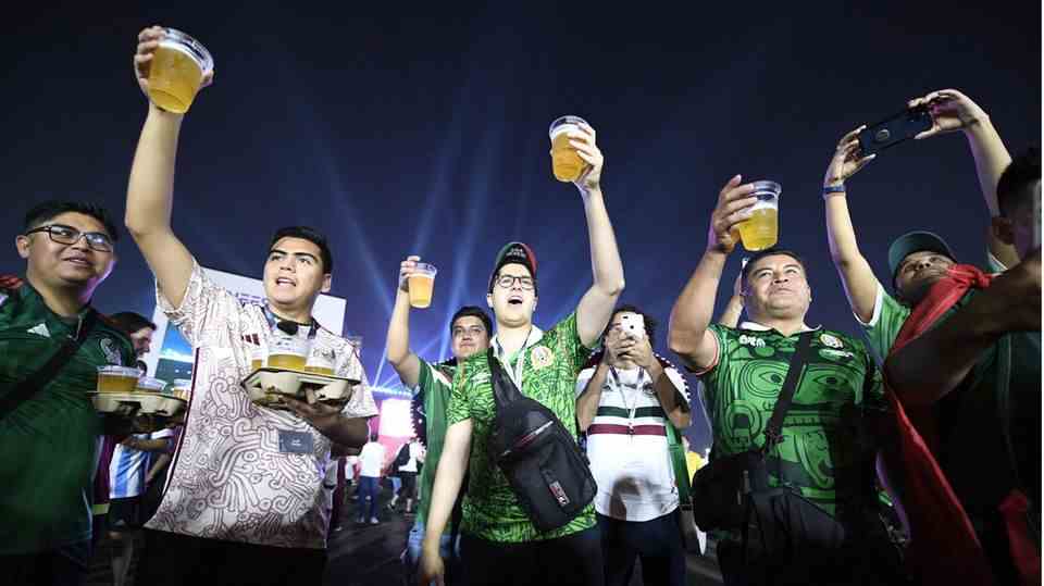 Football fans with beer at the FIFA World Cup festival in Qatar
