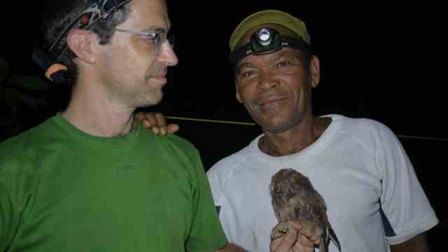Príncipe's Scops Owl: Portuguese ornithologist Martim Melo with bird collector Ceciliano do Bom Jesus and a specimen of the newly discovered species of owl.