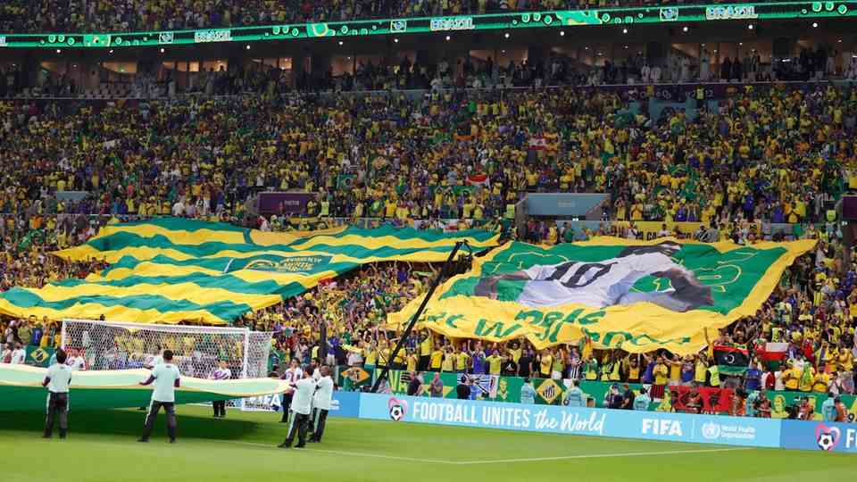 Fans carry a banner that reads Pelé get well soon