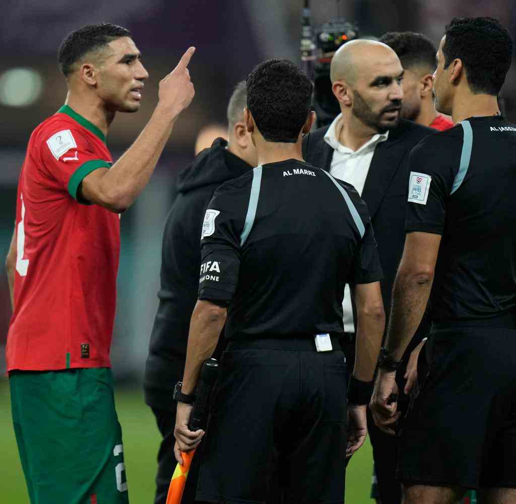 Riots: Morocco's Achraf Hakimi (left) gestures towards the referee.  Coach Walid Regragui appeased