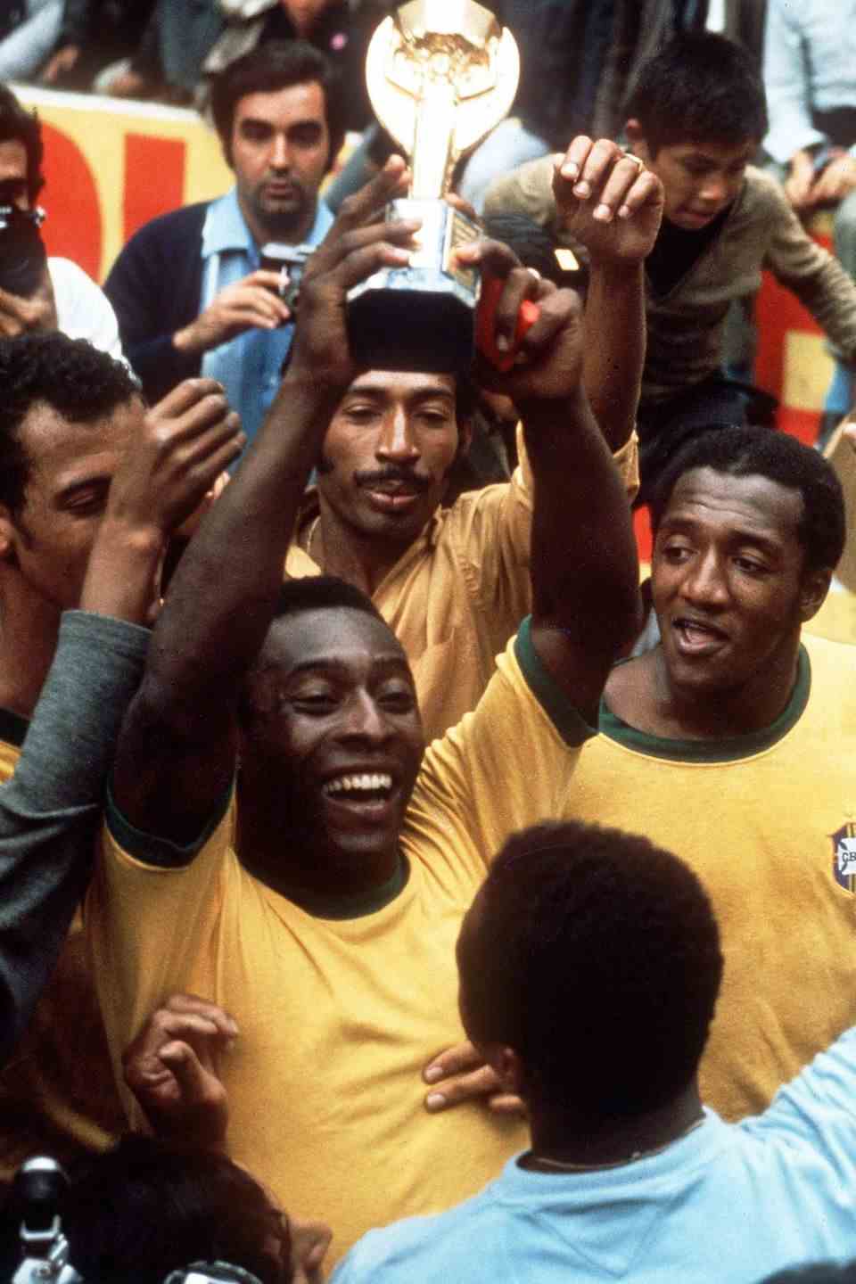 Pele with the 1970 World Cup trophy. When he holds up the trophy, he is not yet wearing a sombrero.