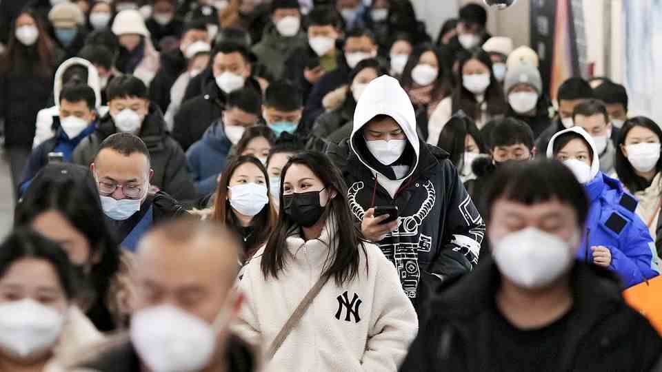 People walk through a subway station in Beijing.