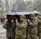 Ukrainian soldiers bury a killed comrade