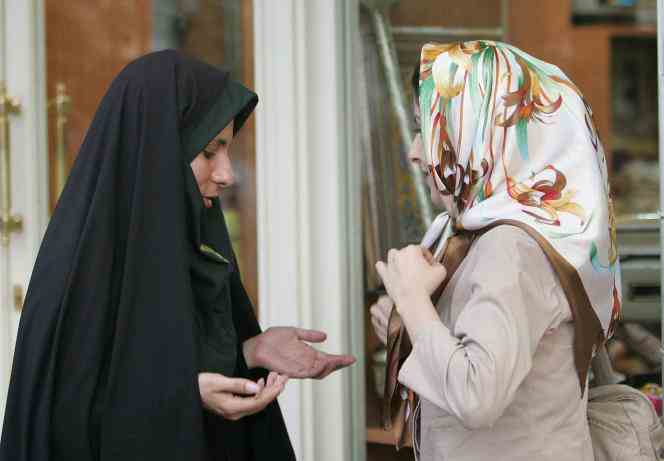 An Iranian policewoman (left) during a strict dress code check in July 2007 in Tehran.