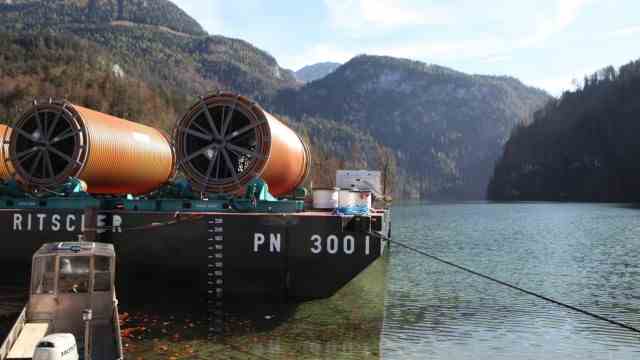 In the middle of Schönau: parts of a sewage pipe for the Königssee lie rolled up on a pontoon before they are laid.