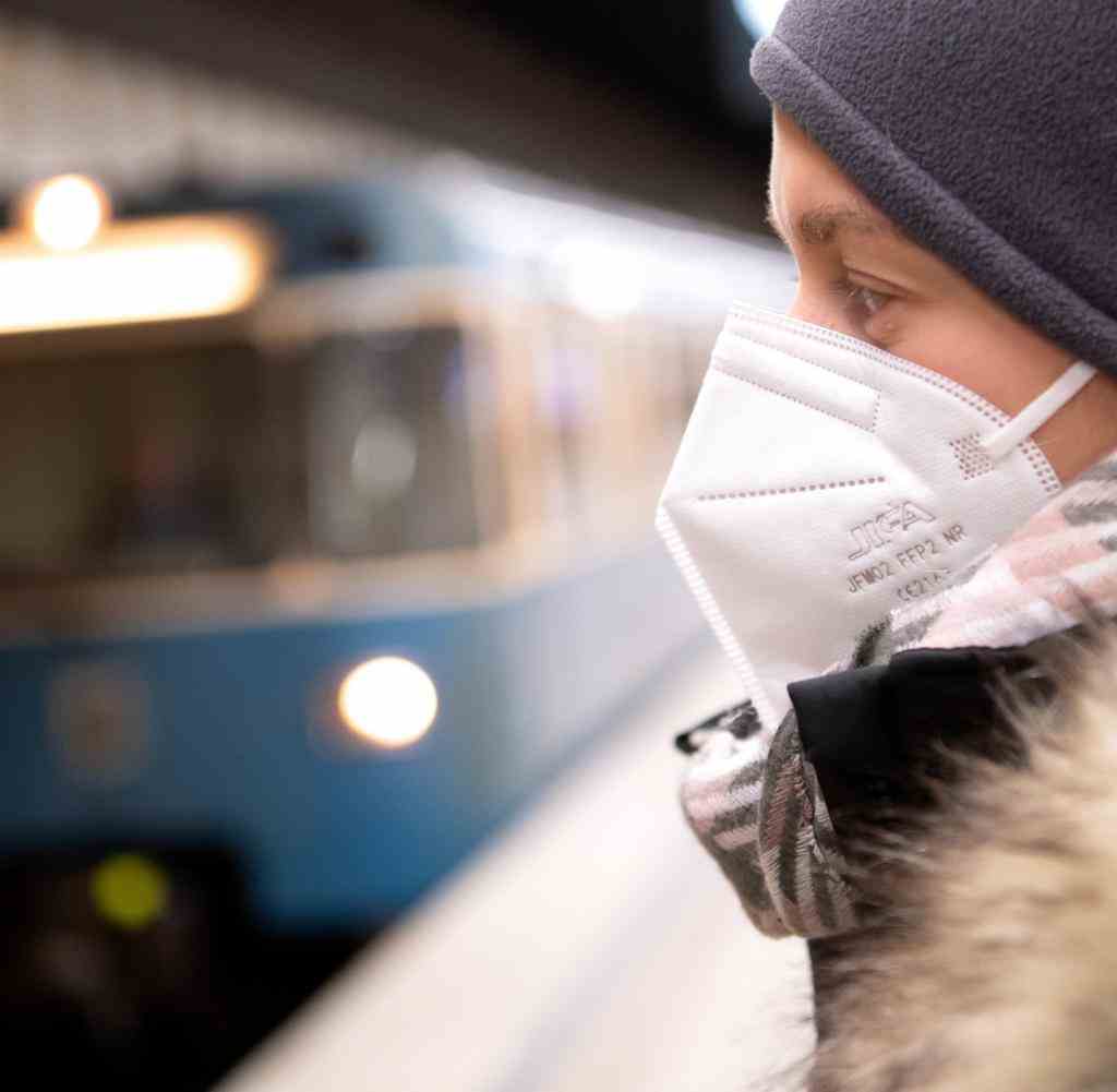 A woman wearing an FFP2 mask is waiting for the train in a subway station.  Here in Munich, the obligation to wear face masks on local public transport has ended