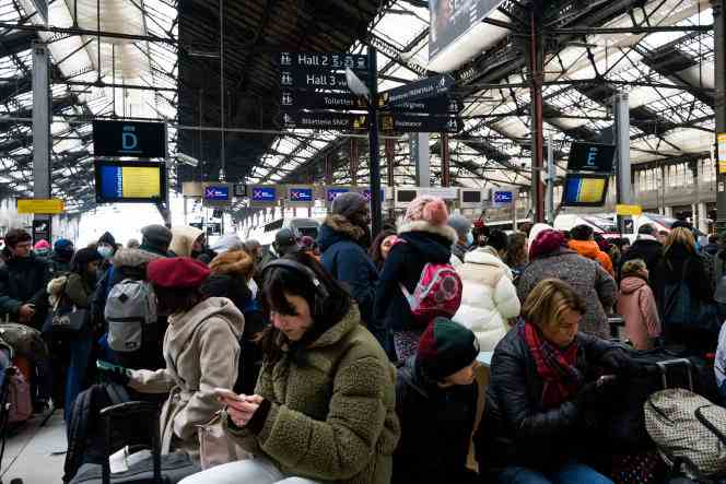 Travelers wait for their train at the Gare de Lyon, while a strike movement blocks part of the traffic, in Paris, on December 17, 2022. 