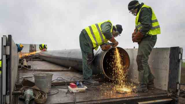 Lithuania: Workers prepare a replacement pipe for the pipeline.