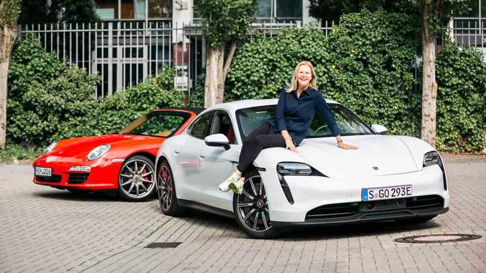 Daniela Sachs Rollmann sits on the bonnet of the Porsche Taycan