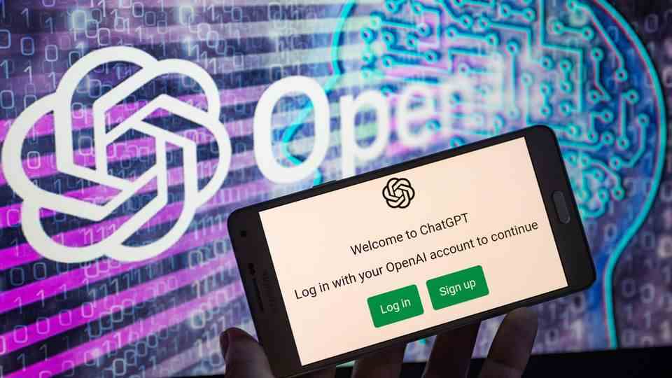 A smartphone with the chatbot ChatGPT open, the logo in the background "OpenAI"