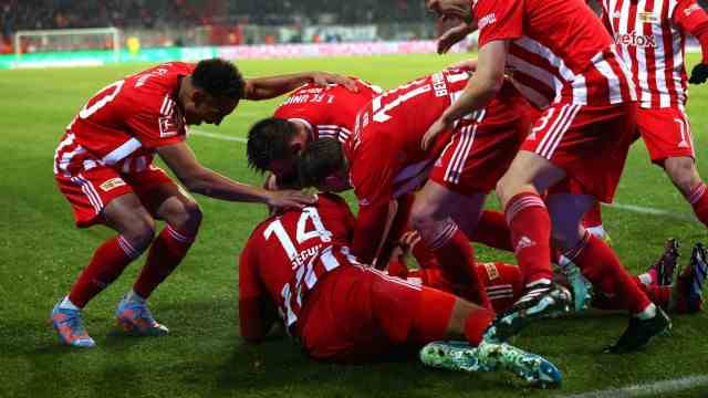 Bundesliga: Danilho Doekhi is buried by his teammates after scoring to make it 2-1.