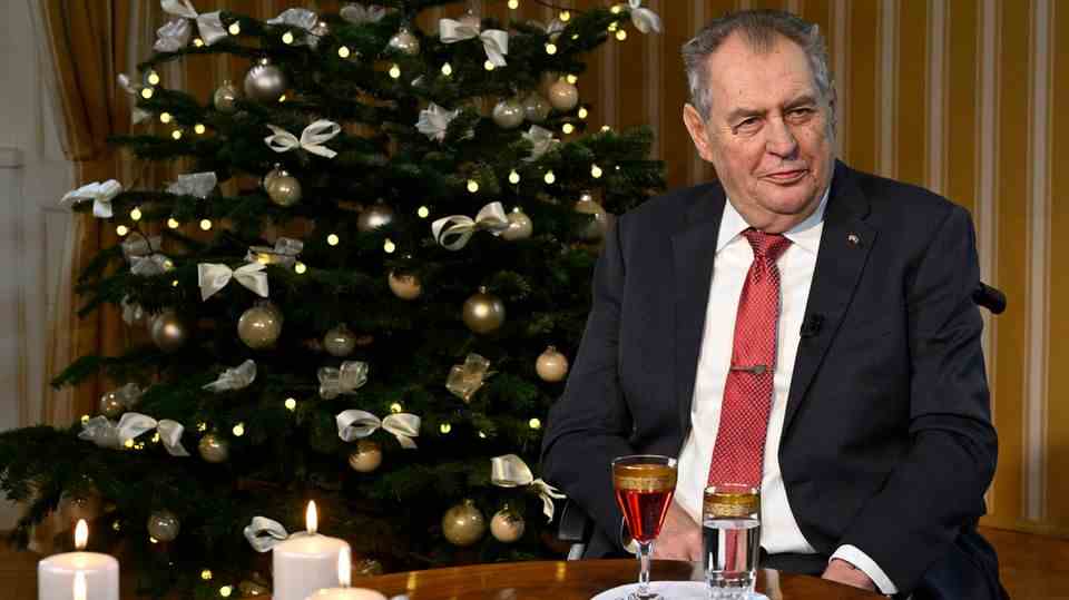 Milos Zeman, President of the Czech Republic, shortly before his Christmas speech.  He is sitting at a table in front of a Christmas tree