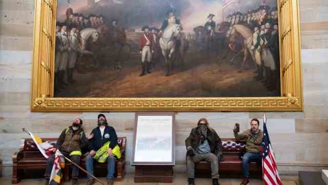 The Political Book: January 6, 2021: Supporters of President-elect Donald Trump rest after the storming of the Capitol - under a painting from the early days of the United States.  It depicts the final surrender of the British after the Battle of Yorktown in 1781.