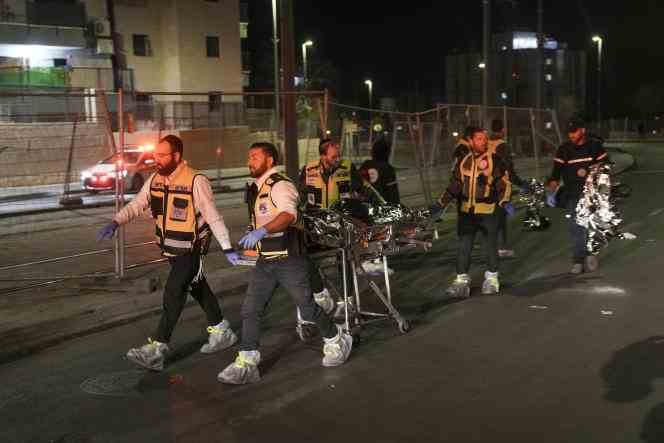 Rescuers evacuate a body after a shooting near a synagogue in Jerusalem on January 27, 2023. 