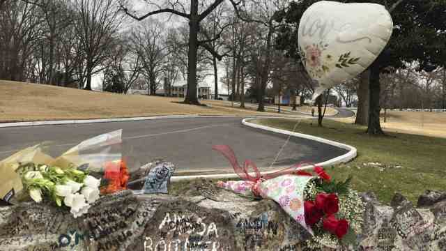 Sudden Death: Flowers and a balloon for Lisa Marie Presley on the stone wall surrounding Presley's Graceland estate.