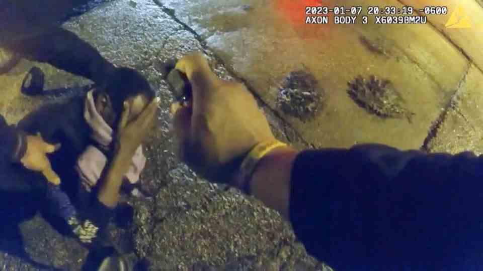 8:33 p.m., Jan. 7, Memphis: A police officer sprays something in Tire Nichols' face.  He rubs his eyes.