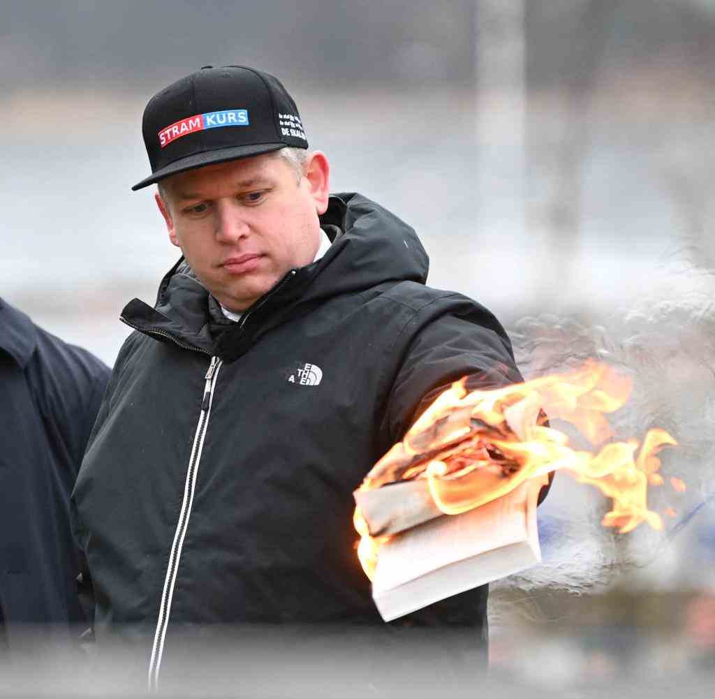 Right-wing extremist Rasmus Paludan burns a copy of the Koran in Stockholm