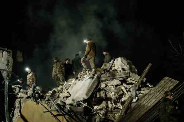 Rescuers on the debris of an apartment building hit by a strike, in Kramatorsk, Ukraine, February 2, 2023