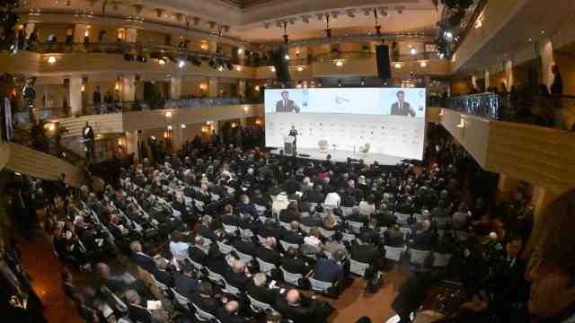 Munich Security Conference: Politicians speak in this hall.  This is Emmanuel Macron speaking.