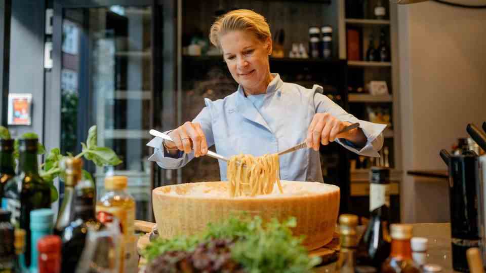 Cornelia Poletto turns pasta in a huge loaf of parmesan
