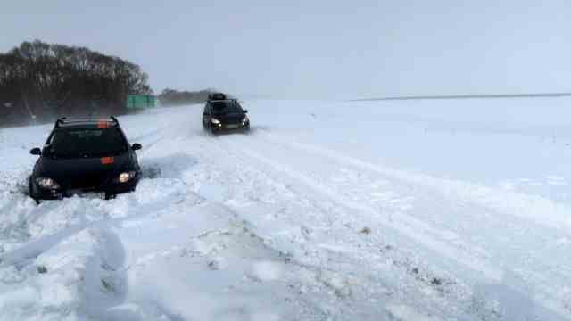 Onset of winter: near Poprad in Slovakia, a car is stuck in the snow on the road to the airport on Saturday.