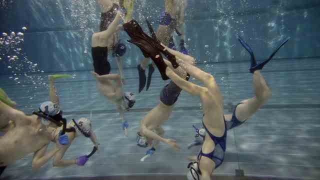 Underwater hockey: people are constantly diving up and down again.