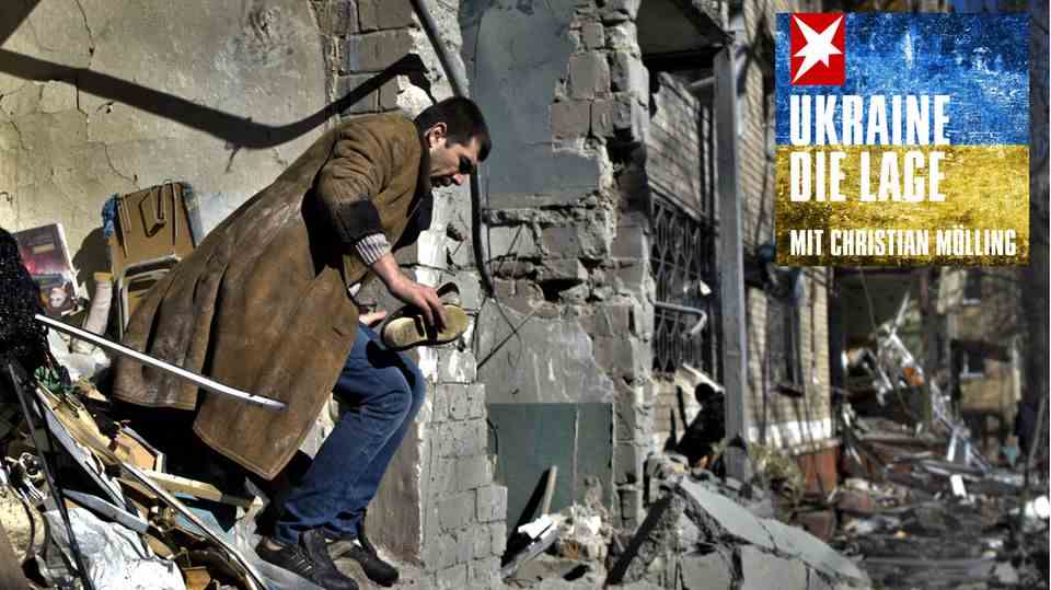 A resident climbs out of a house in Kramatorsk that was destroyed by Russian shells