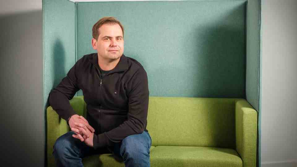 CEO Jaroslaw Kutylowski and founder of DeepL sits on a sofa at the company's headquarters in Cologne