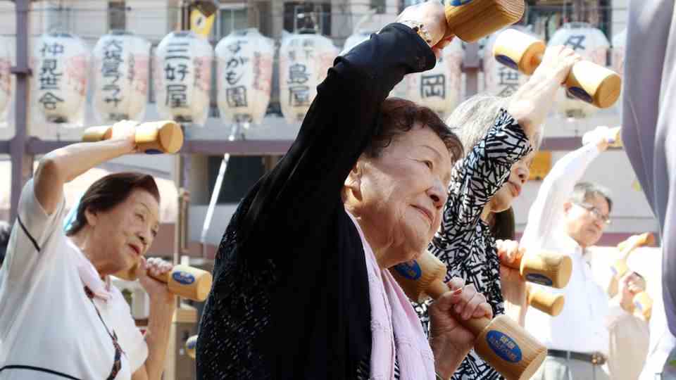 Older Japanese women exercise outdoors