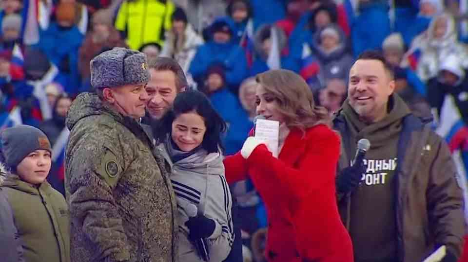 ann "hugs" Yuri Gagarin on stage at Luzhniki Stadium