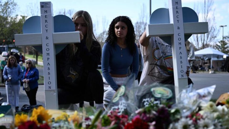 People mourn at a memorial for the victims of the Nashville elementary school shooting
