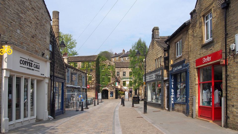 A street in Hebden Bridge lined with cafés and small shops