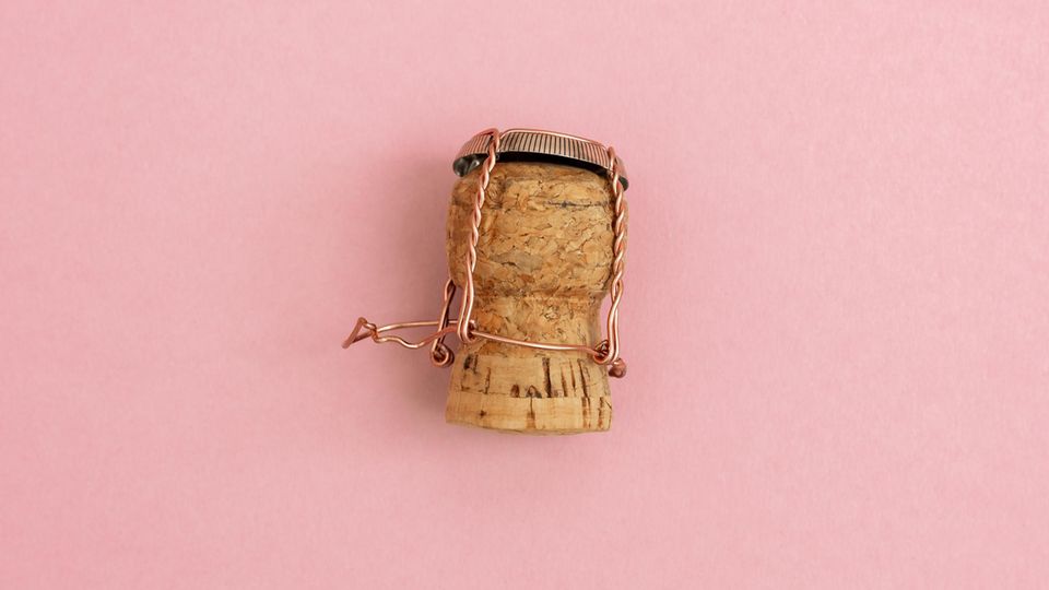 Champagne cork on a pink background
