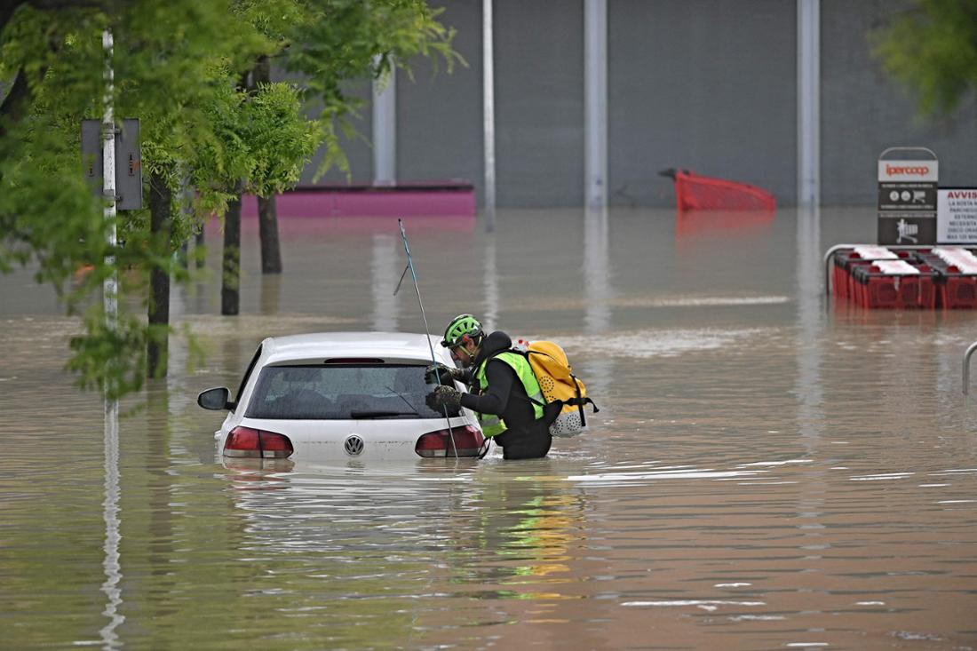 Alpine rescuers search for missing persons near a supermarket in Cesena (Italy).  