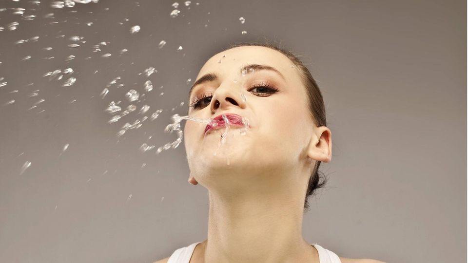 Woman spits out liquid