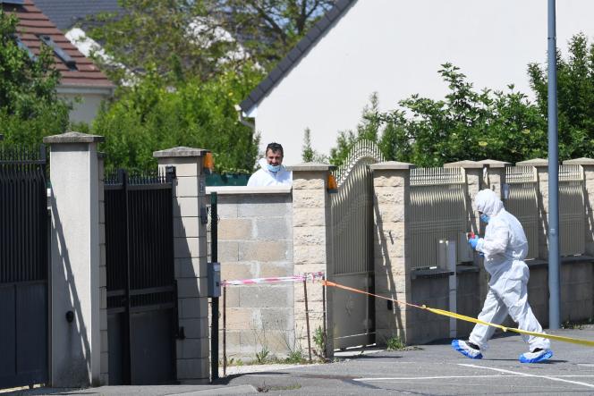 Forensic officers at the entrance to the house where the bodies of a woman and two children were found, in Dreux, May 25, 2023.
